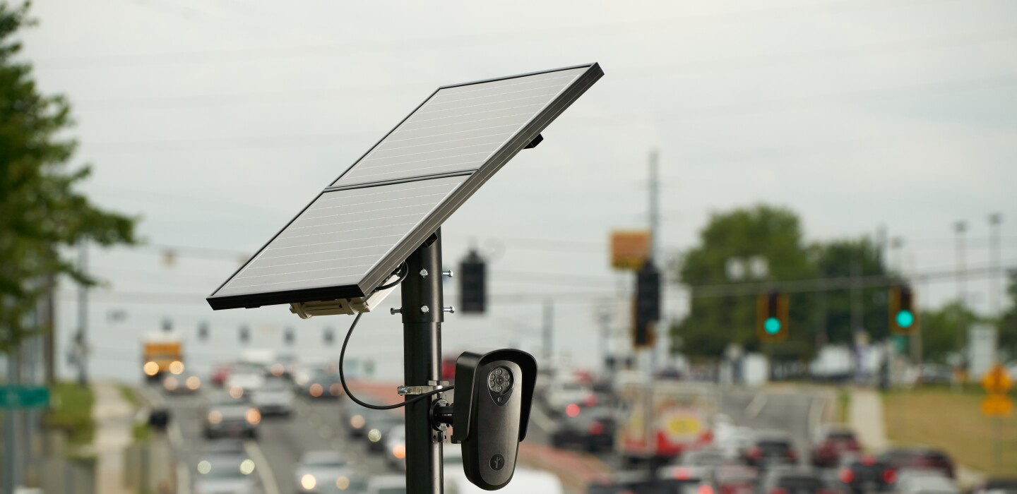 Rows of automated license plate reader cameras watching a city street
